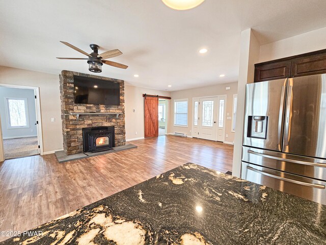 kitchen featuring dark stone countertops, a breakfast bar area, and hanging light fixtures