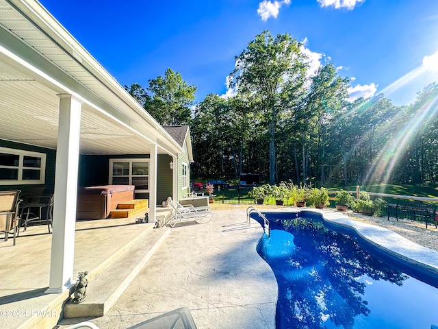 view of pool with a patio and a hot tub