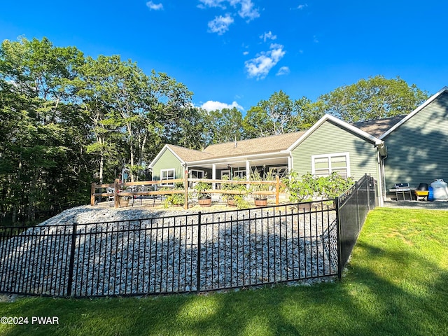 back of house with a lawn