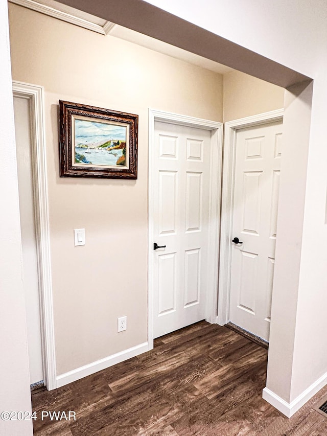 hall with dark hardwood / wood-style flooring