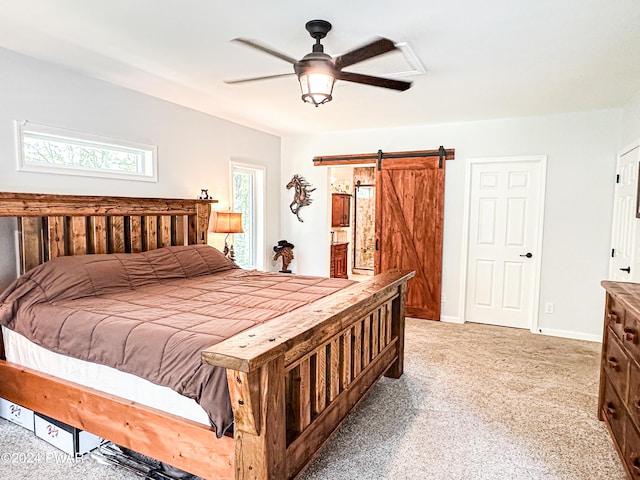 bedroom featuring ceiling fan and a barn door