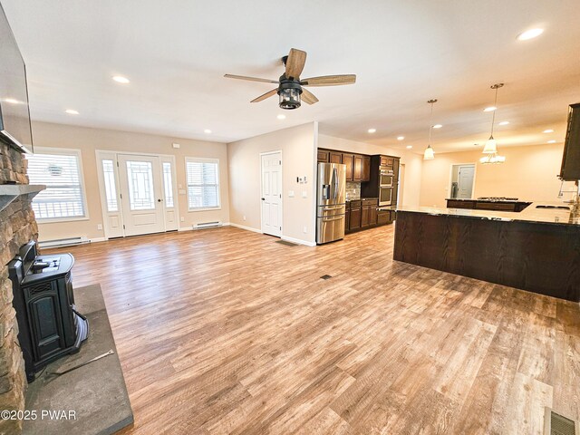 kitchen featuring decorative backsplash, pendant lighting, stainless steel appliances, and sink