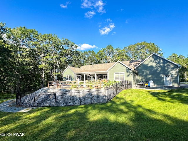 back of property with a yard and a patio