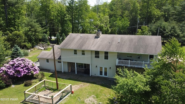 177 Crane Rd, Lakeville, PA 18438 - rear view of property featuring french doors, a vegetable garden, a lawn, and a chimney