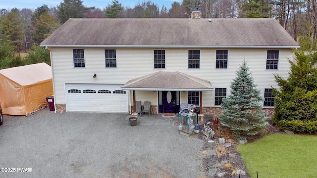 177 Crane Rd, Lakeville, PA 18438 - colonial-style house with a garage, a chimney, stone siding, and asphalt driveway