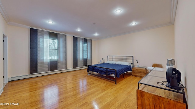 bedroom with light hardwood / wood-style floors, crown molding, and baseboard heating