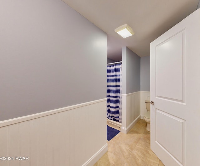 hallway with light tile patterned floors