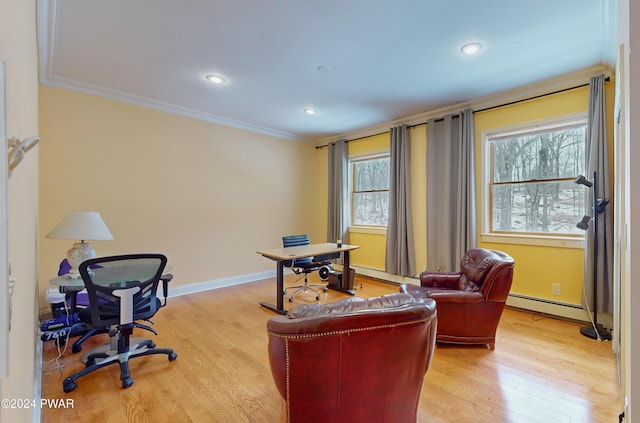 office featuring light hardwood / wood-style floors, ornamental molding, a wealth of natural light, and a baseboard radiator