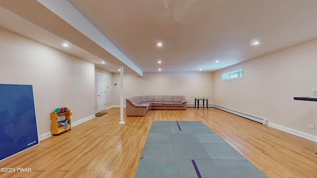 exercise area featuring light hardwood / wood-style floors and baseboard heating