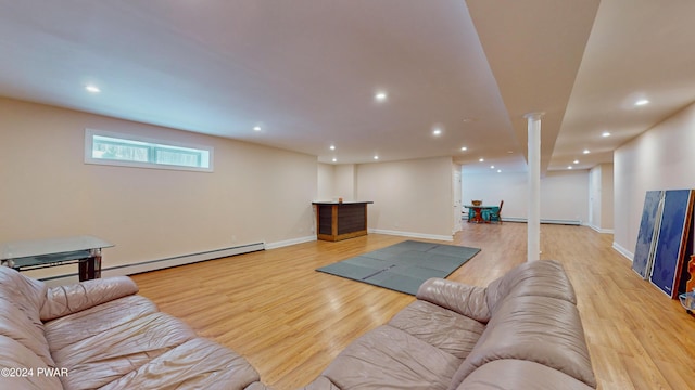 living room featuring light wood-type flooring and a baseboard radiator