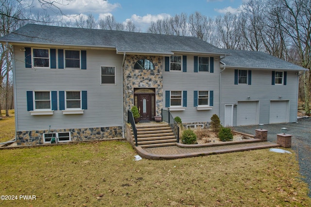 view of front facade with a garage and a front lawn