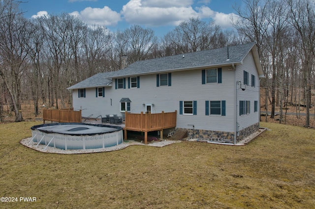 rear view of property featuring a swimming pool side deck and a yard