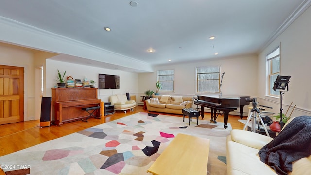 living room with light hardwood / wood-style flooring and crown molding