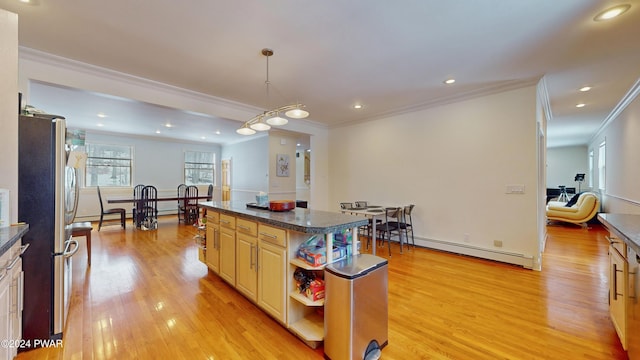 kitchen with pendant lighting, a center island, stainless steel fridge, ornamental molding, and a baseboard radiator