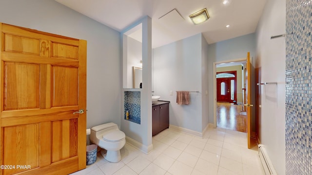 bathroom with tile patterned flooring, toilet, vanity, and a baseboard heating unit