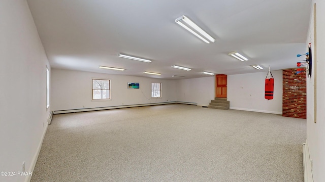 unfurnished room with baseboard heating and light carpet