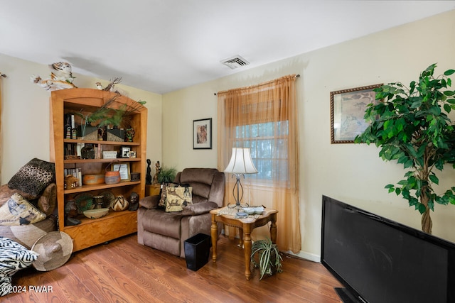 living area featuring a fireplace and wood-type flooring