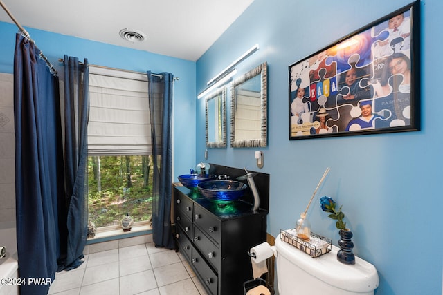 full bathroom with tile patterned flooring, vanity, toilet, and shower / bathtub combination with curtain