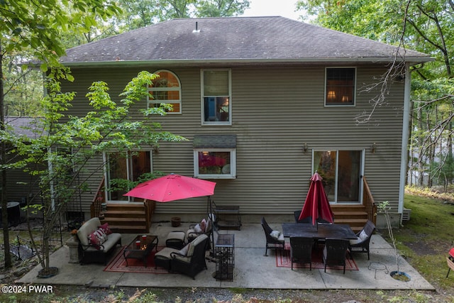 back of property with a patio area and an outdoor hangout area