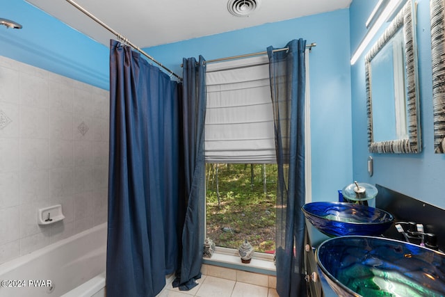 bathroom with tile patterned flooring, double sink, and shower / bath combo with shower curtain