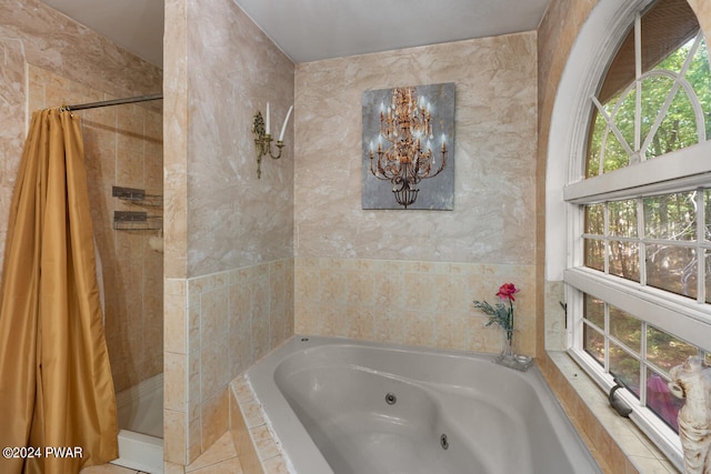 bathroom featuring tile patterned floors, plus walk in shower, and a chandelier