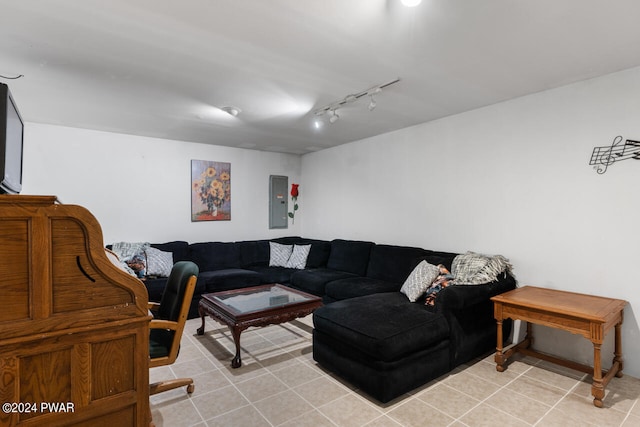 living room with light tile patterned flooring, rail lighting, and electric panel