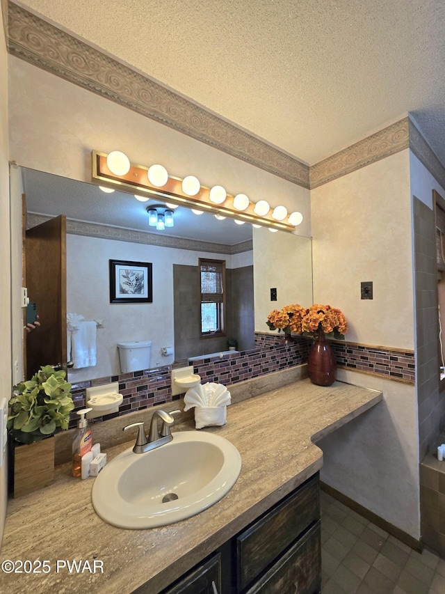 bathroom with a textured ceiling, tile patterned flooring, vanity, backsplash, and toilet