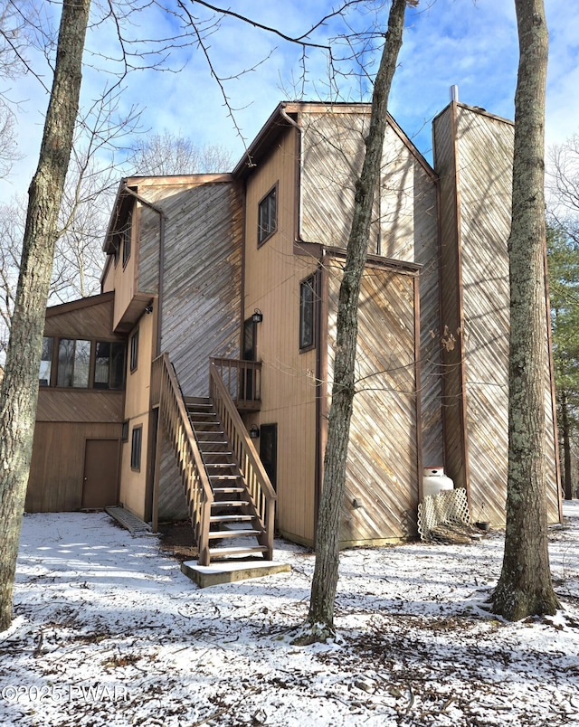 view of snow covered rear of property