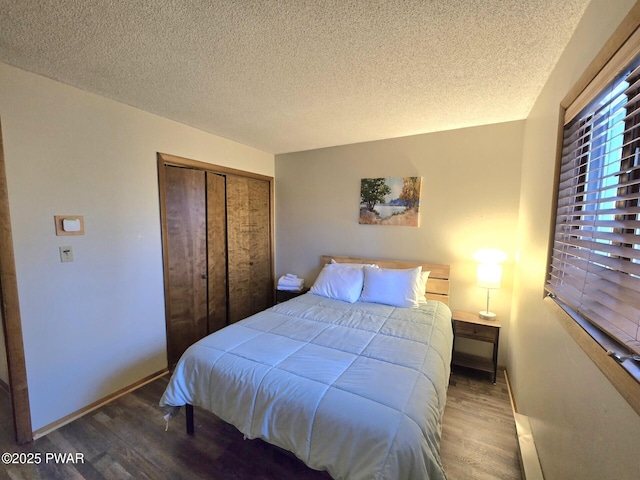 bedroom with hardwood / wood-style flooring, a textured ceiling, and a closet