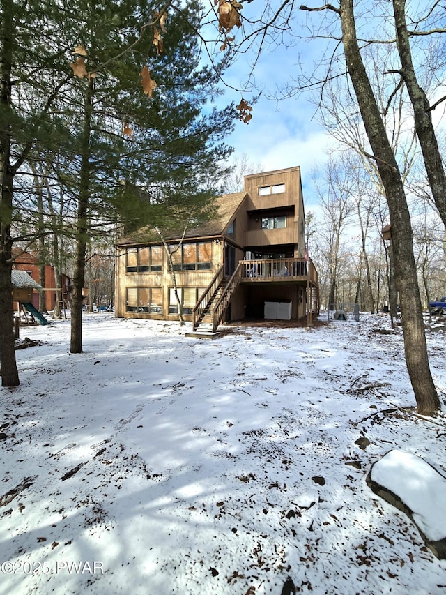 snow covered house with a deck