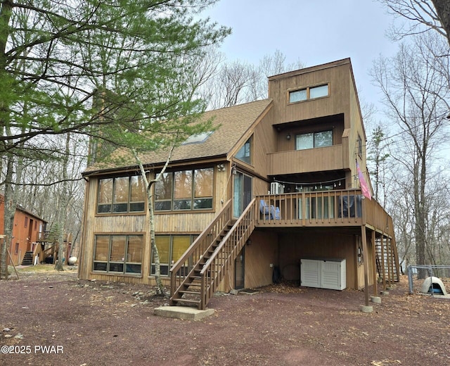 6128 Wales Ct, East Stroudsburg, PA 18301 - rear view of house featuring a sunroom, roof with shingles, a deck, and stairs