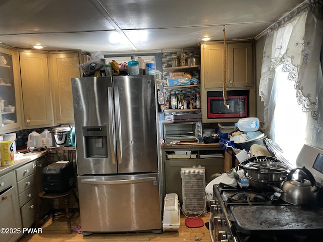 kitchen with stainless steel appliances, light wood-type flooring, a toaster, and glass insert cabinets