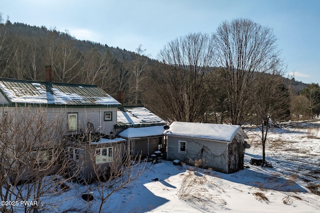 exterior space featuring a wooded view