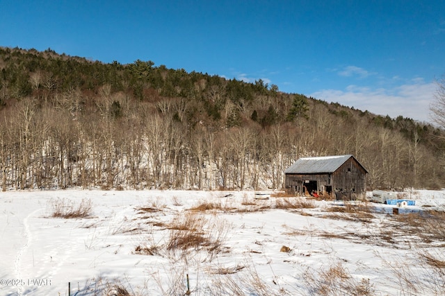 exterior space with a wooded view