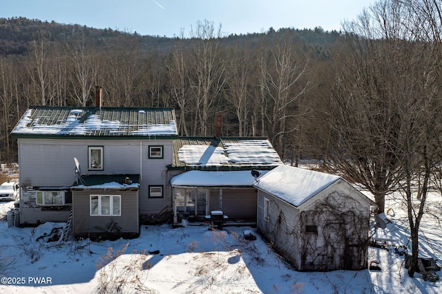 view of front facade featuring a forest view