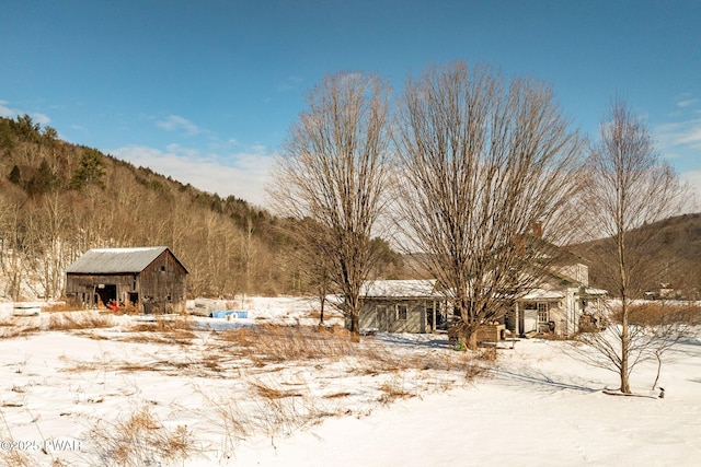 yard covered in snow with an outdoor structure