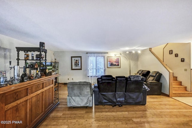 living room with wood-type flooring and bar area