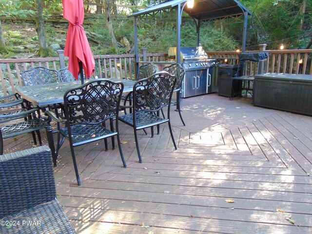 wooden terrace featuring grilling area