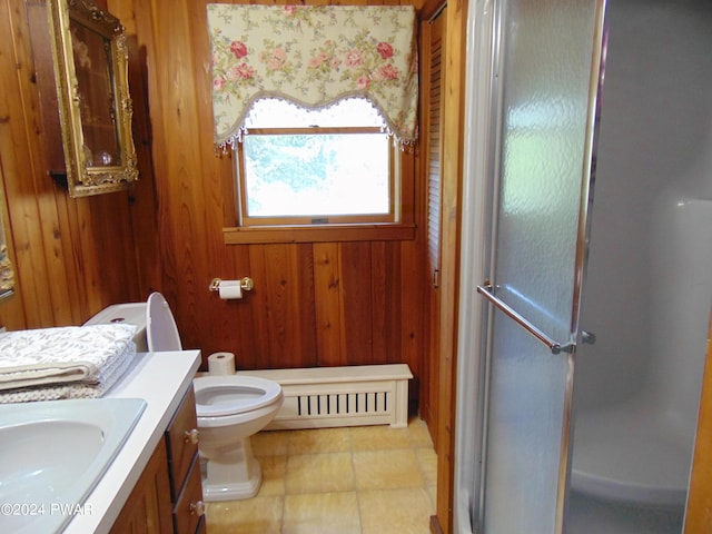 bathroom featuring a baseboard radiator, wood walls, toilet, a shower with door, and vanity