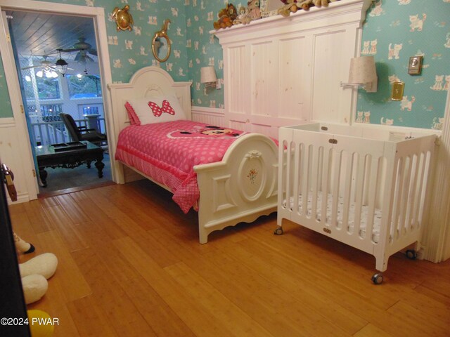 bedroom with hardwood / wood-style flooring and radiator heating unit