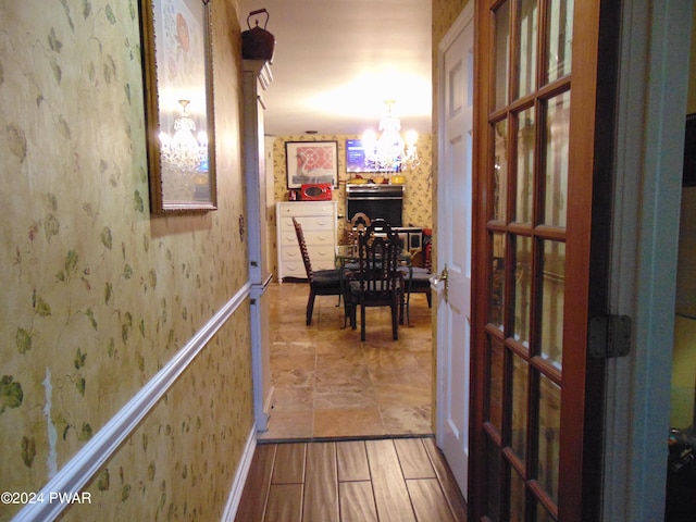 corridor featuring a notable chandelier