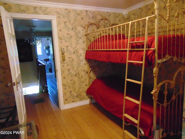 bedroom with wood-type flooring and crown molding