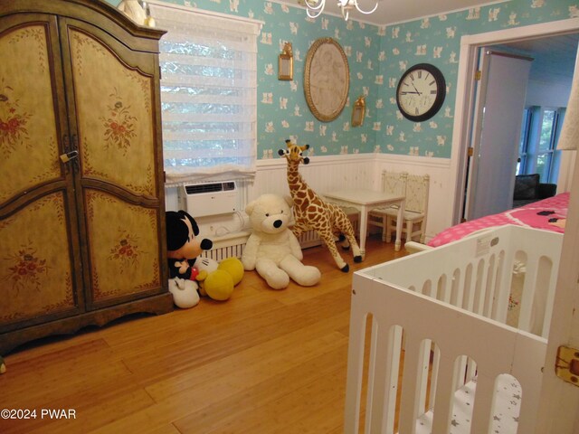 bedroom featuring hardwood / wood-style flooring and cooling unit