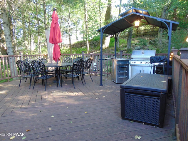 wooden deck featuring a grill