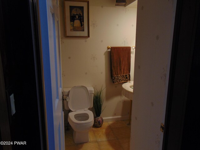 bathroom featuring tile patterned flooring and toilet