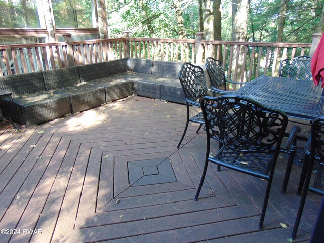 wooden terrace featuring outdoor lounge area