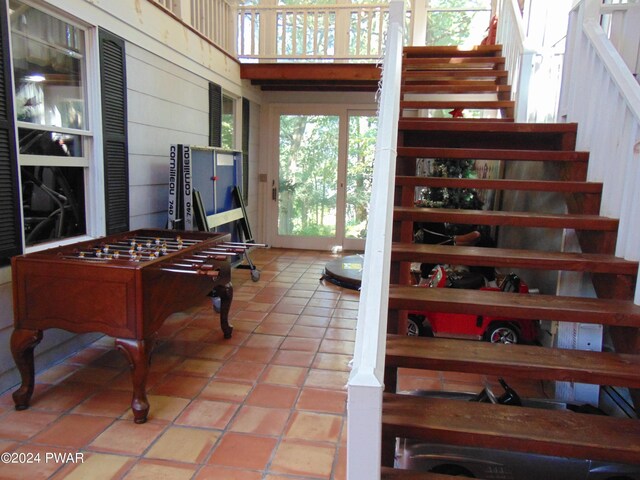 interior space featuring tile patterned flooring and wooden walls