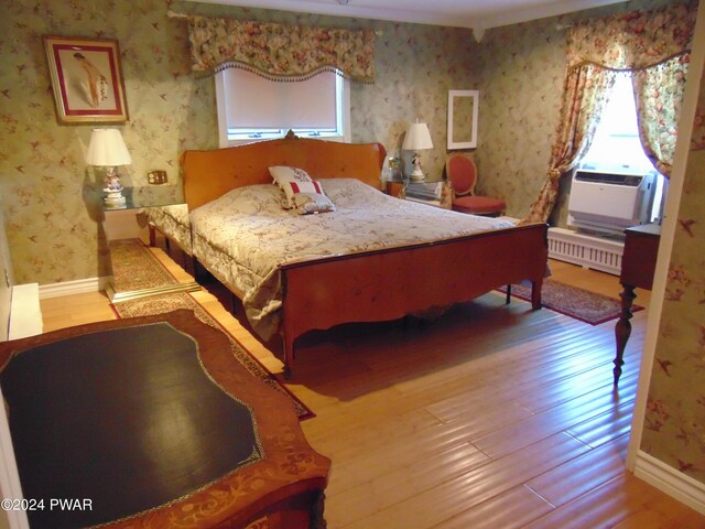 bedroom featuring hardwood / wood-style floors and cooling unit