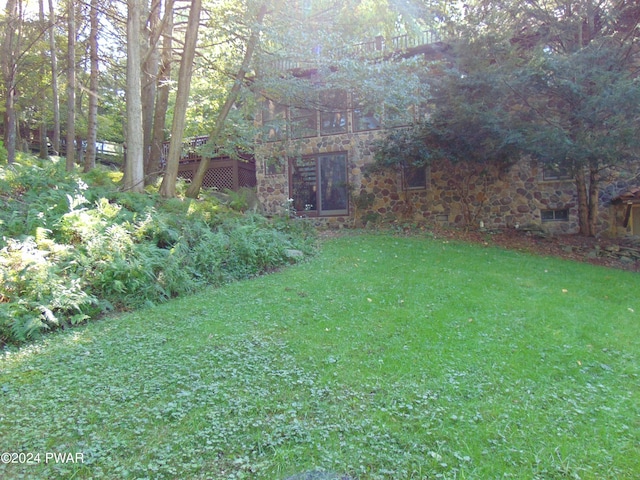 view of yard featuring a wooden deck