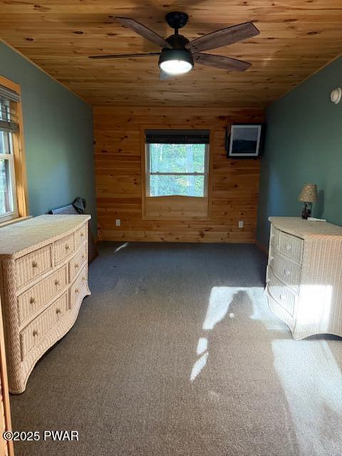 1030 Evergreen Dr, Lake Ariel, PA 18436 - bedroom featuring wooden ceiling, lofted ceiling, wood walls, dark colored carpet, and ceiling fan
